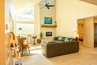 Modern living room with a brown sectional sofa, coffee table, and decorative items.